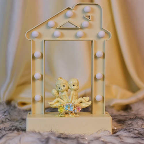 Couple Figurine Sitting In LED Light Frame